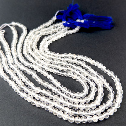 Crystal smooth round gemstone beads in 5mm size arranged on a 32cm strand with bright reflective shine.