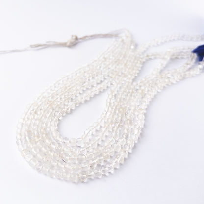 crystal smooth round beads arranged neatly on a long strand with clean transparent finish.  