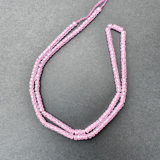 Pink Cubic Zirconia faceted rondelle beads with blush sparkle arranged on a 37cm strand for jewellery making.