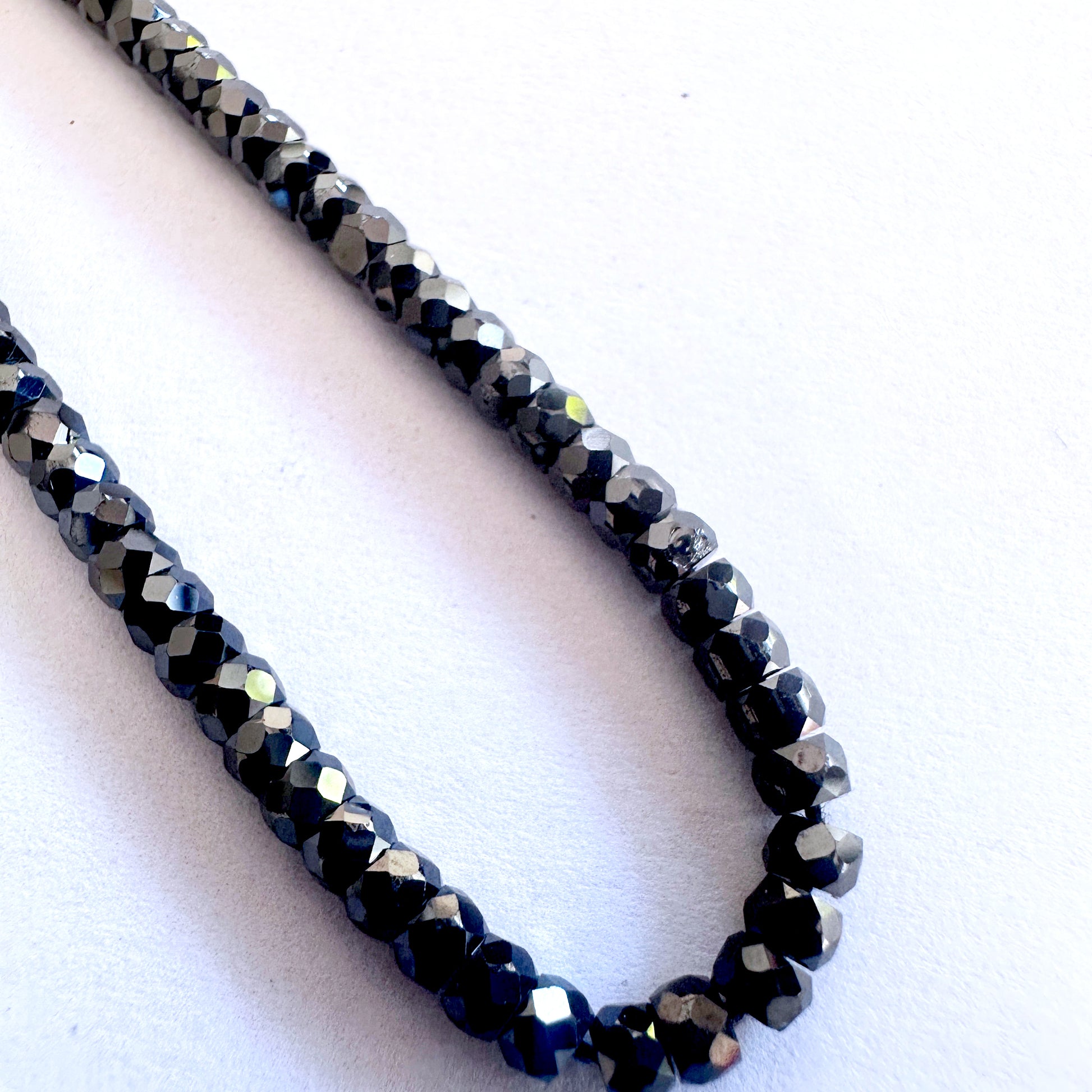Strand of Black Cubic Zirconia beads featuring precision faceting and smooth surface texture.
