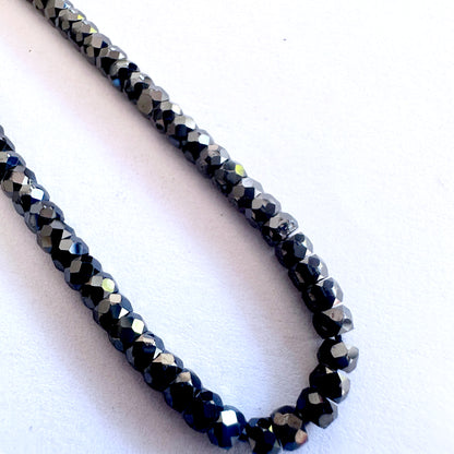Strand of Black Cubic Zirconia beads featuring precision faceting and smooth surface texture.