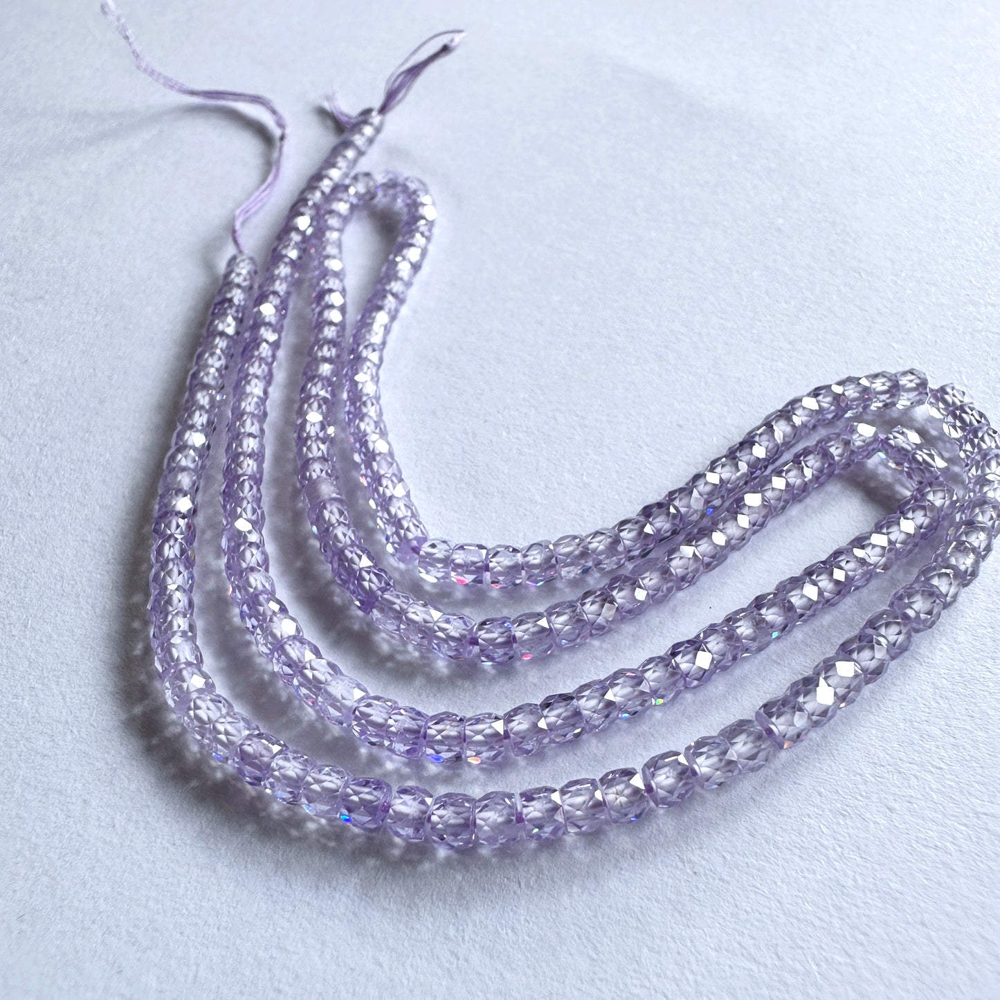 A dial gauge measures the Cubic Zirconia faceted rondelle 3mm gemstone.