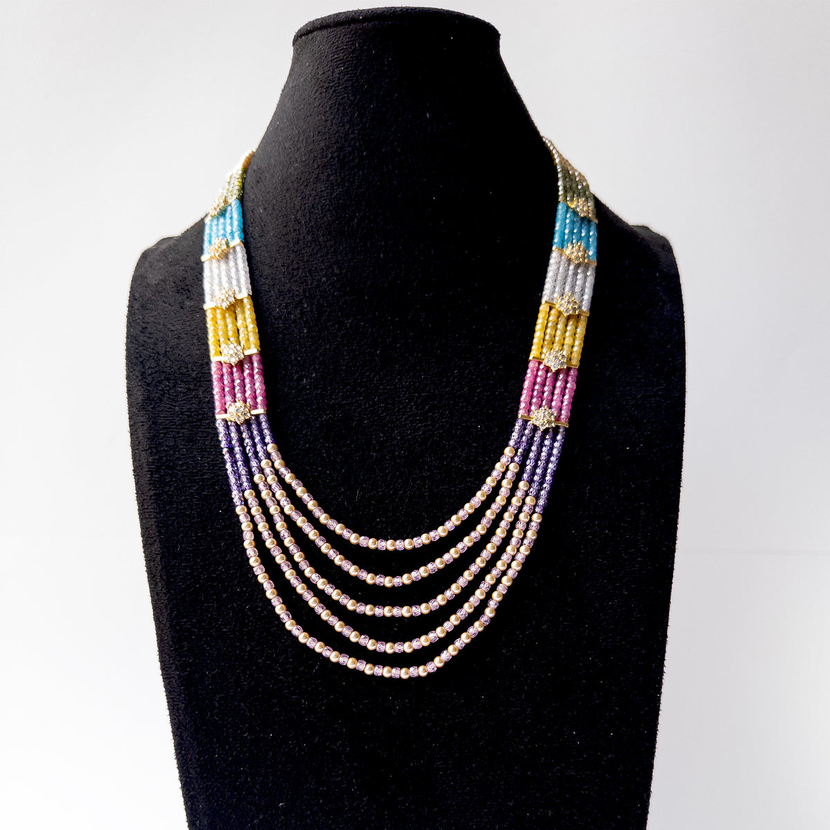 Five strand Cubic Zirconia and Shell Pearl necklace with cascading layers that add elegance and graceful movement.