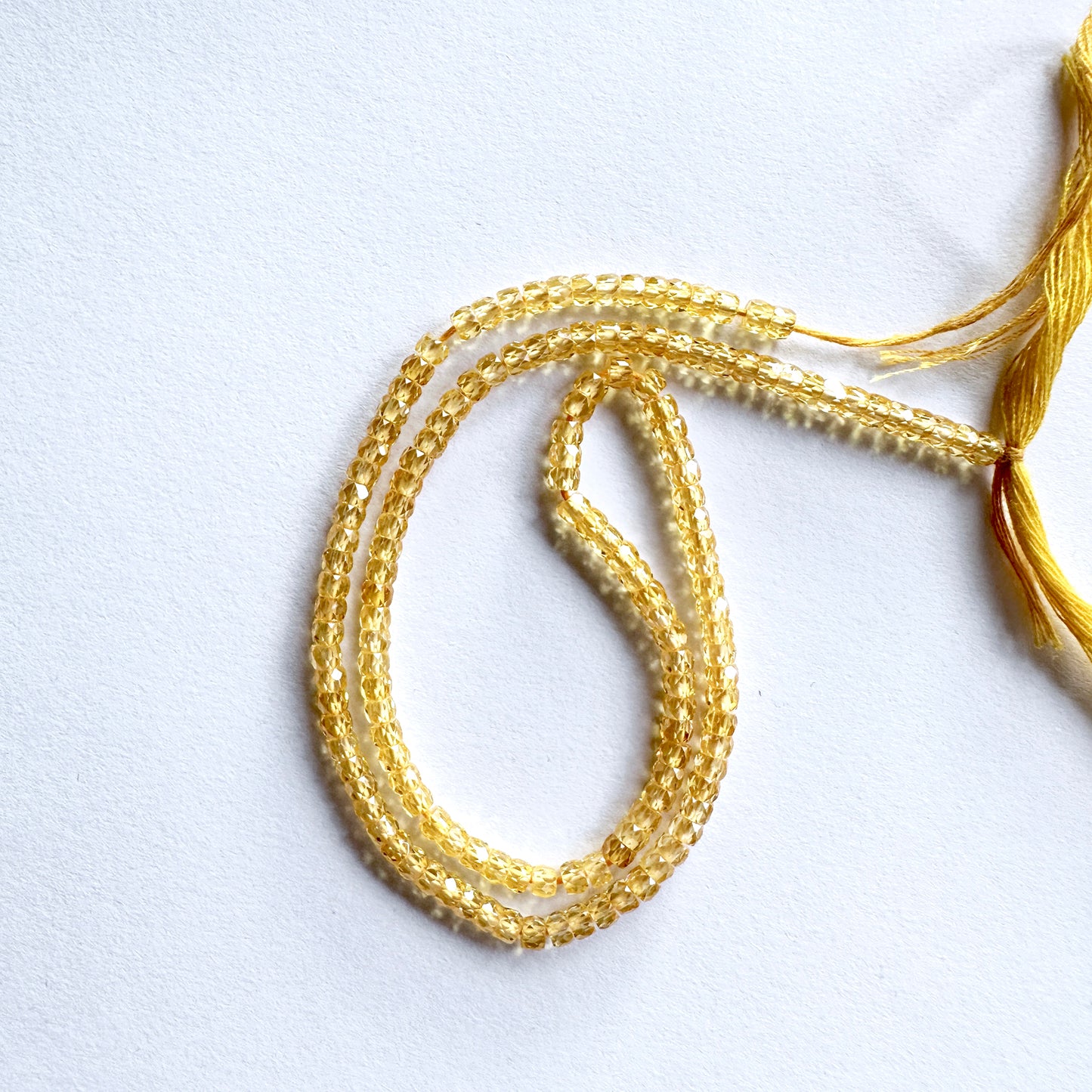 Strand of Yellow Cubic Zirconia beads with 0.4mm drill holes for precision threading.