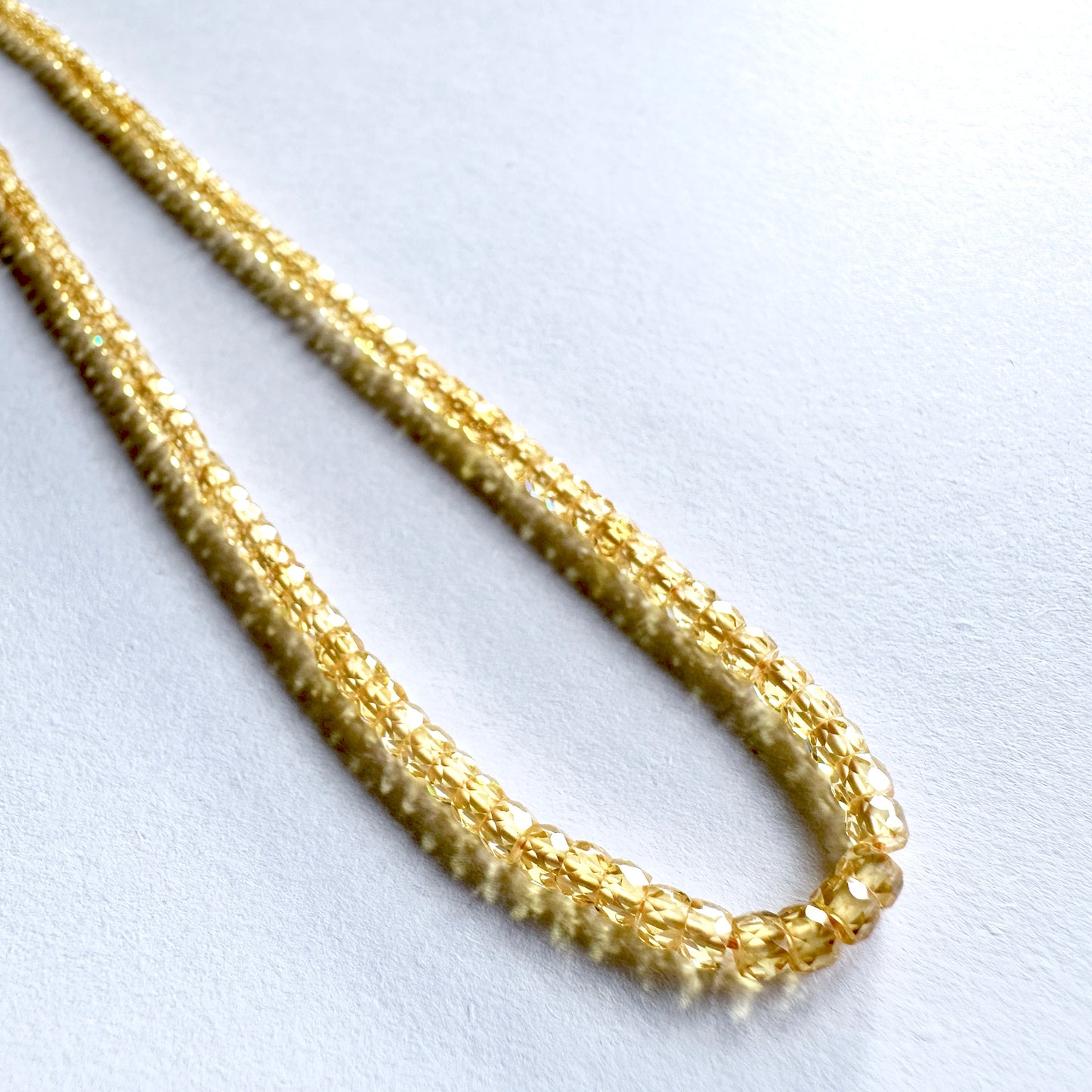 Faceted Yellow Cubic Zirconia gemstones with uniform rondelle shape and vivid colour.