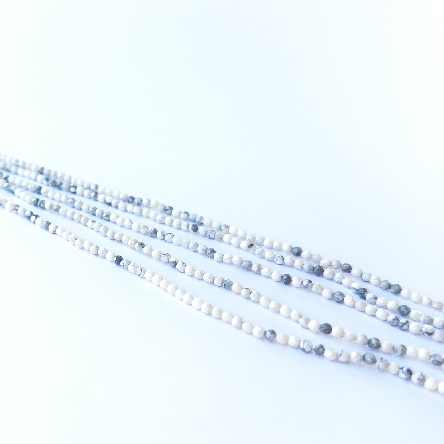 Dendrite Opal rondelle beads showcasing their glossy finish, pattern variation and premium craftsmanship