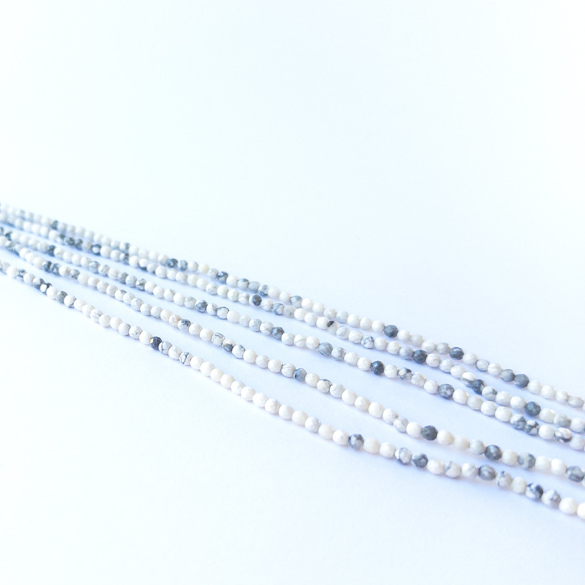 Dendrite Opal rondelle beads showcasing their glossy finish, pattern variation and premium craftsmanship