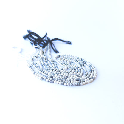 Handmade jewellery components featuring smooth, sparkling Dendrite Opal rondelle gemstone beads.