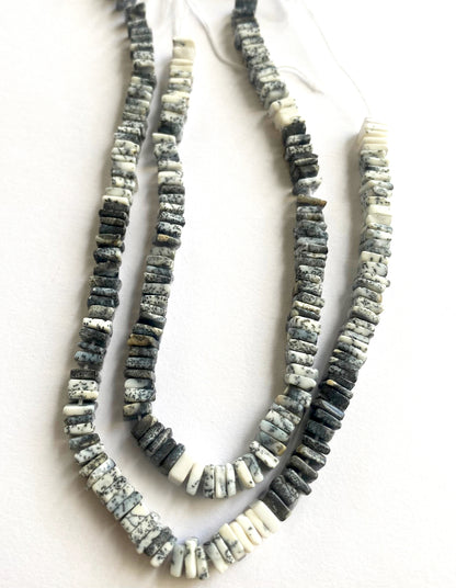 Square-cut Dendrite Opals laid flat on a display surface to reveal texture and colour depth.