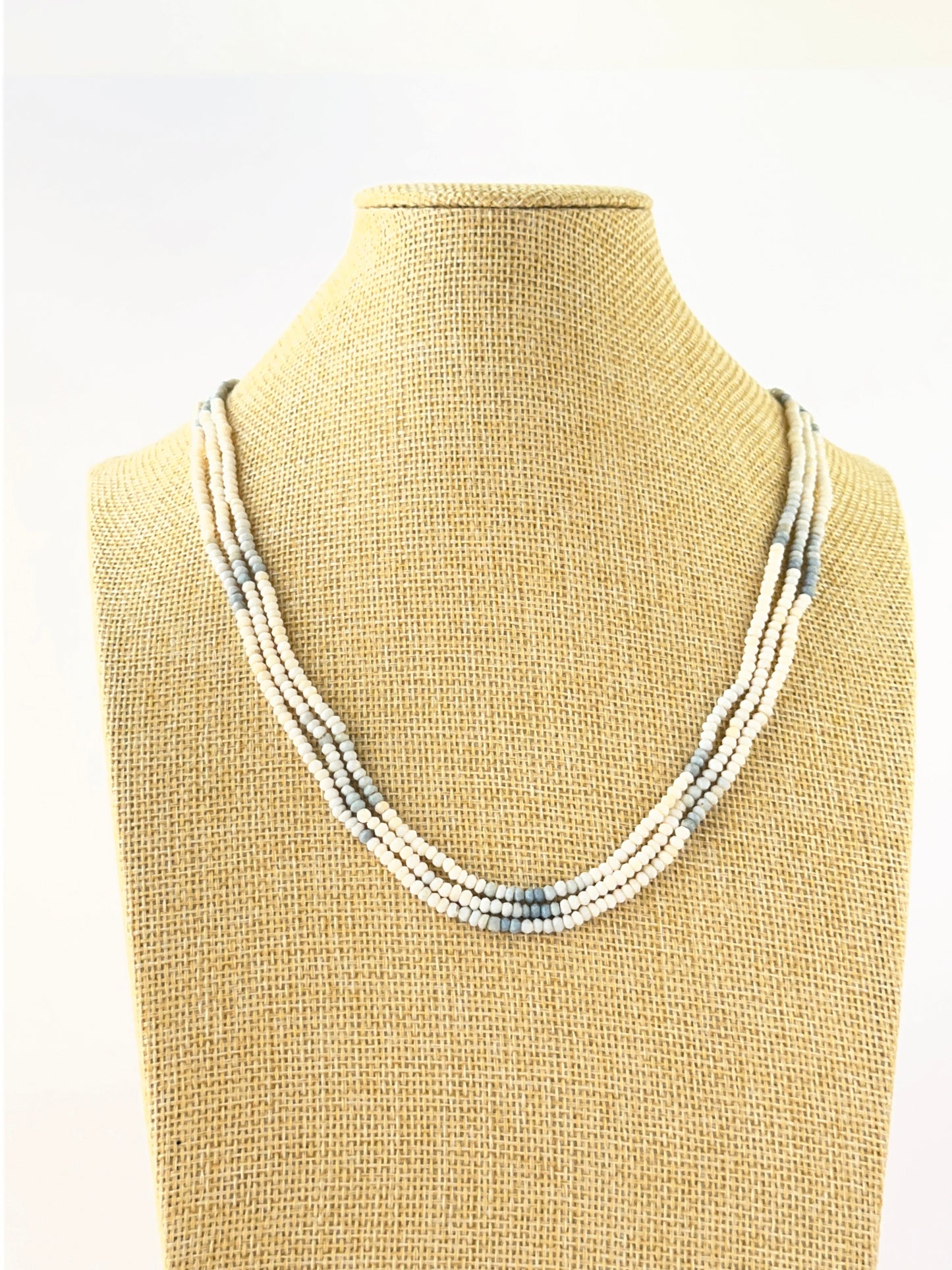 Three‑strand denim opal necklace featuring faceted rondelle beads sized 3–3.4mm in layered lengths.