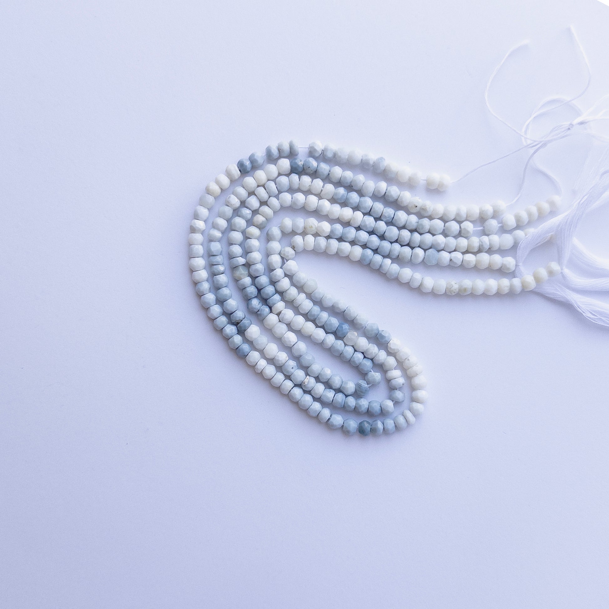 Denim Opal faceted rondelle beads in 4.6–4.7mm, showing soft denim‑blue tones for handmade jewellery components.
