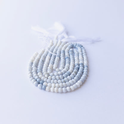 Close‑up of Denim Opal faceted rondelle beads highlighting sparkle, colour variation, and quality for DIY jewellery making.
