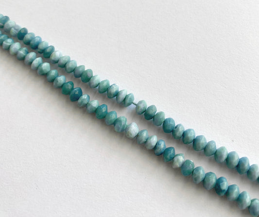 Denim opal faceted rondelle beads in soft blue-grey tones, arranged on a 16cm strand.