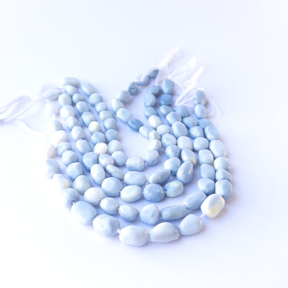 Authentic denim opal gemstone beads with polished smooth tumble cuts, ideal for handmade jewellery components.
