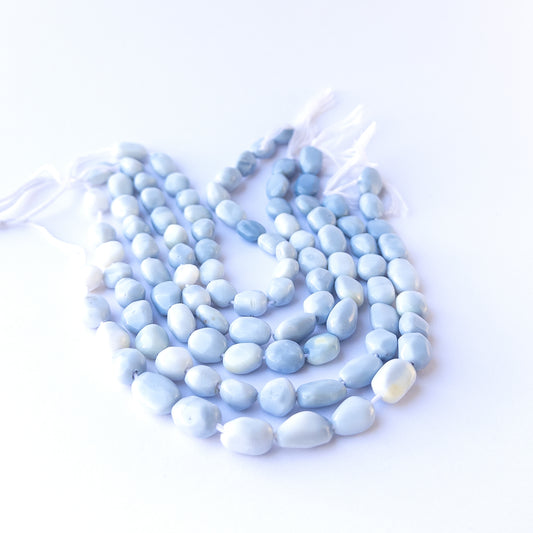 Authentic denim opal gemstone beads with polished smooth tumble cuts, ideal for handmade jewellery components.