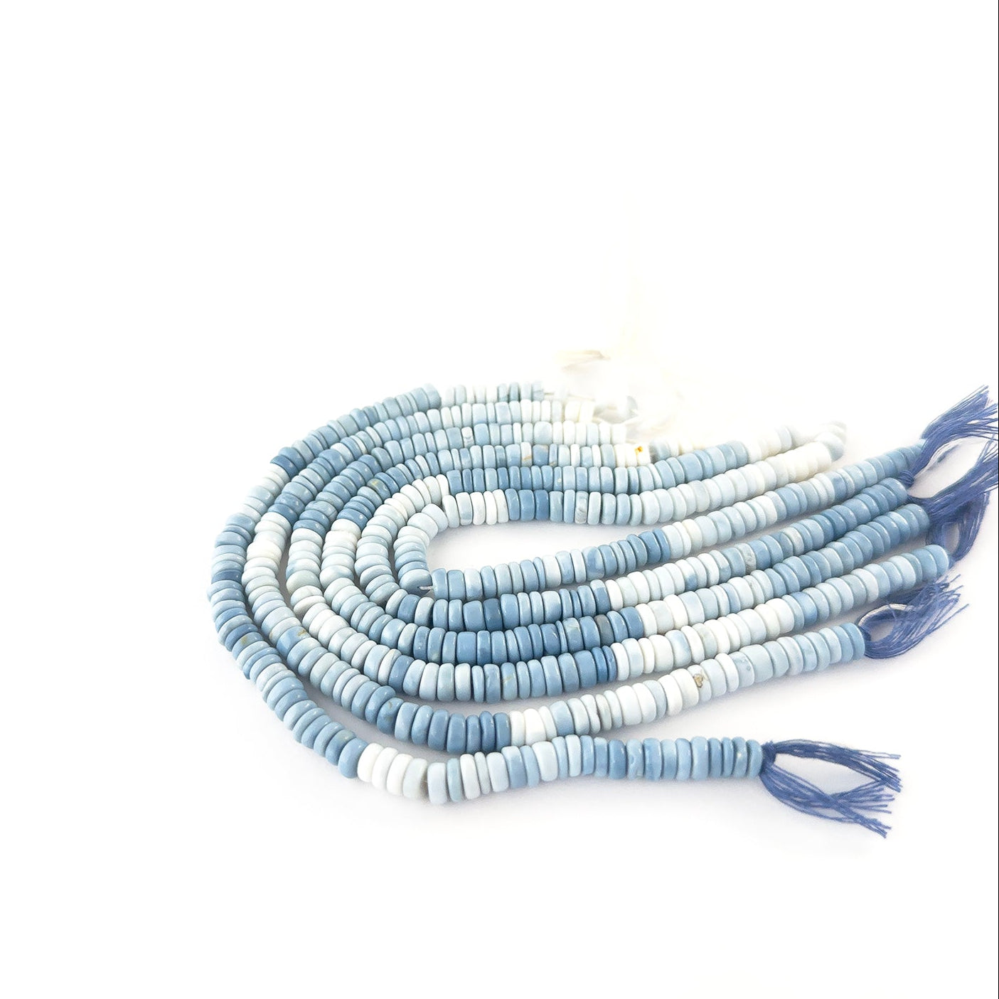 Denim Opal smooth wheel beads sized 6–6.5mm or 7mm arranged in a 20cm strand, showing soft denim‑blue tones and a polished finish.
