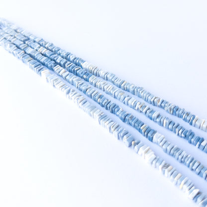 Handmade jewellery components featuring authentic Denim Opal square heishi beads with soft denim‑blue colour.