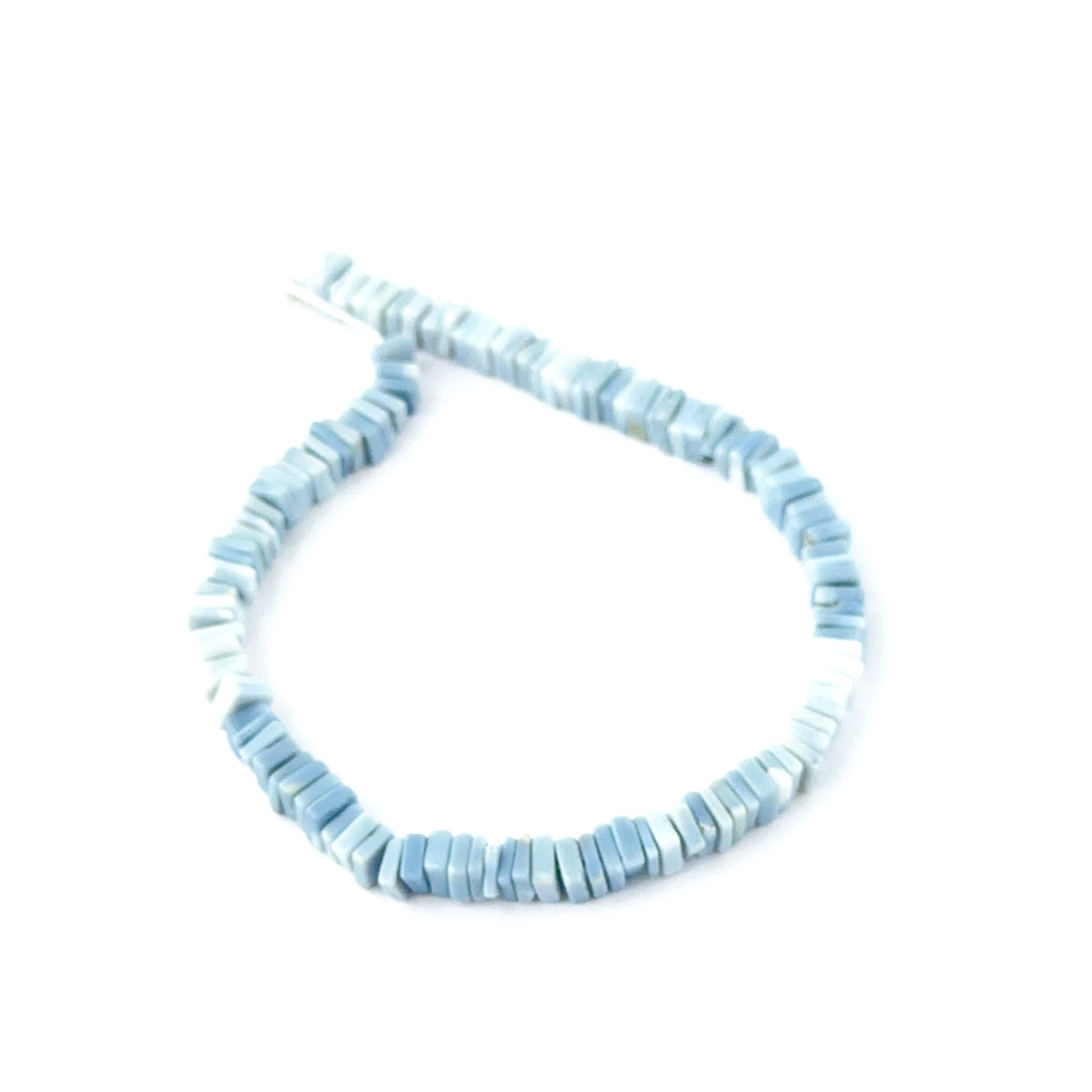 Natural Denim Opal Heishi beads showing soft blue tones and square‑cut texture.