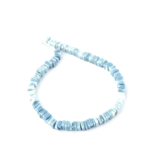 Natural Denim Opal Heishi beads showing soft blue tones and square‑cut texture.