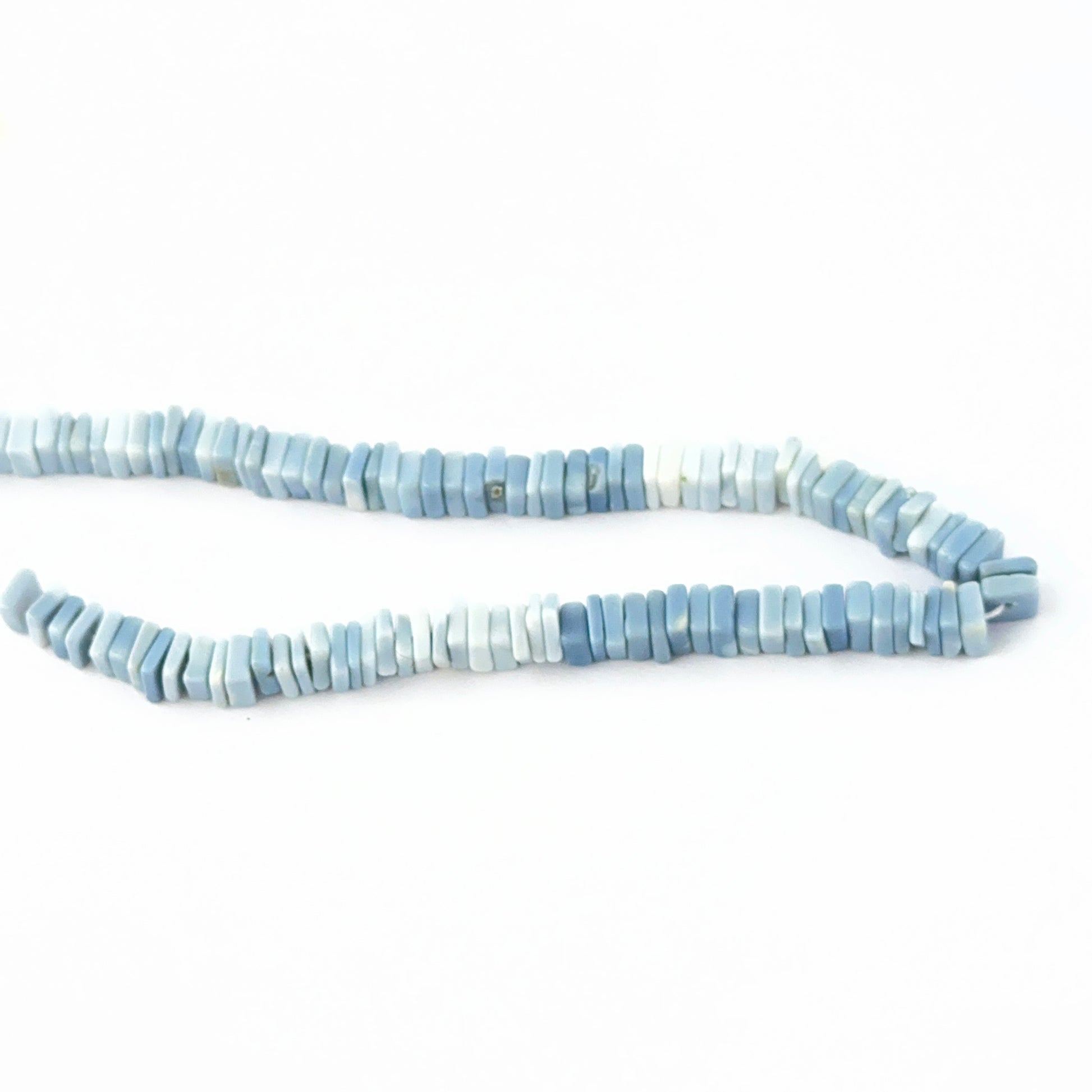 Denim Opal 5–5.3mm Heishi beads with natural marbling and clean edges.