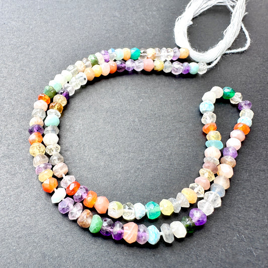 Disco faceted rondelle beads with shimmering multi-tonal sparkle arranged on a 33cm strand for jewellery making.