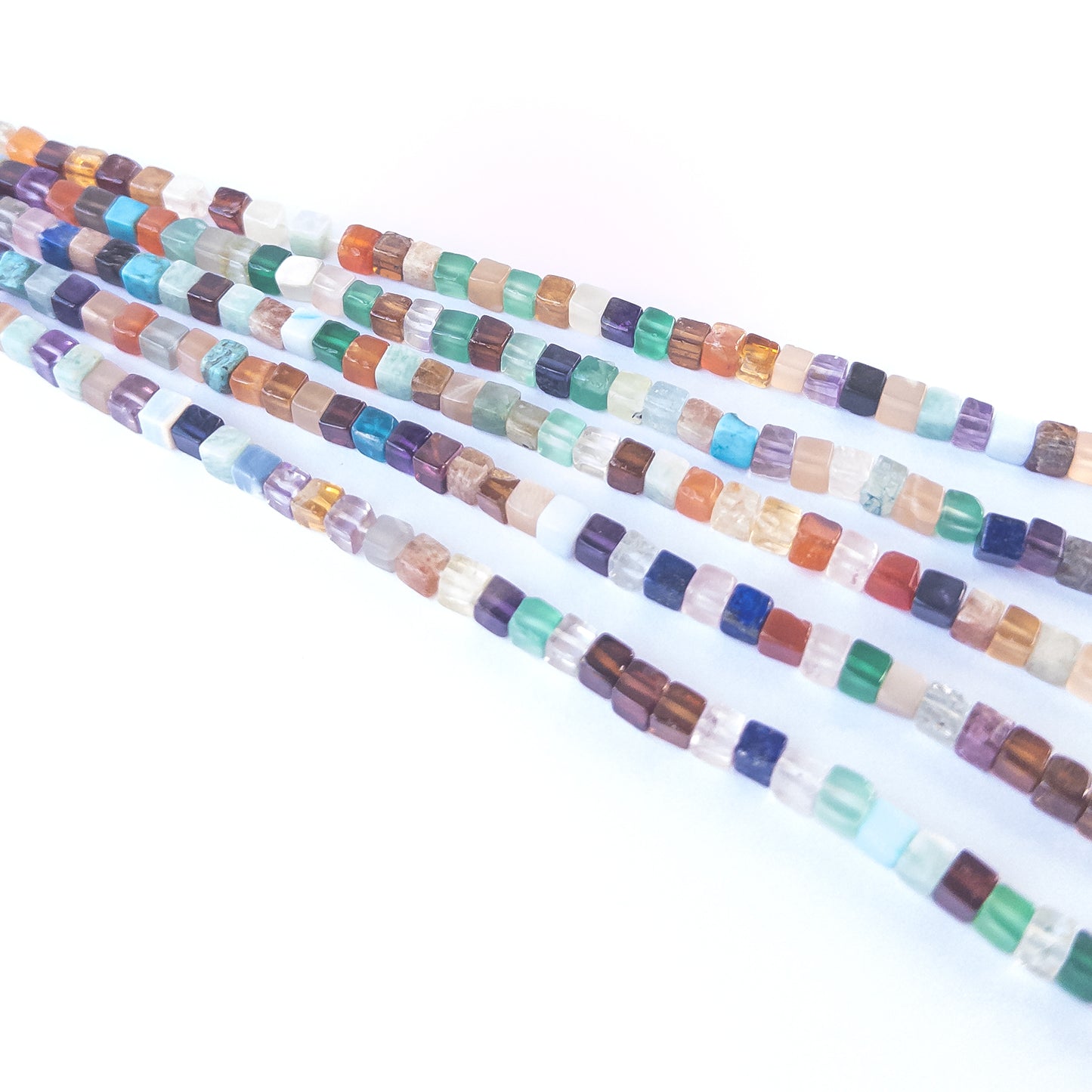 Close‑up of Disco smooth cube beads showing their reflective finish, clean shaping and modern metallic look.