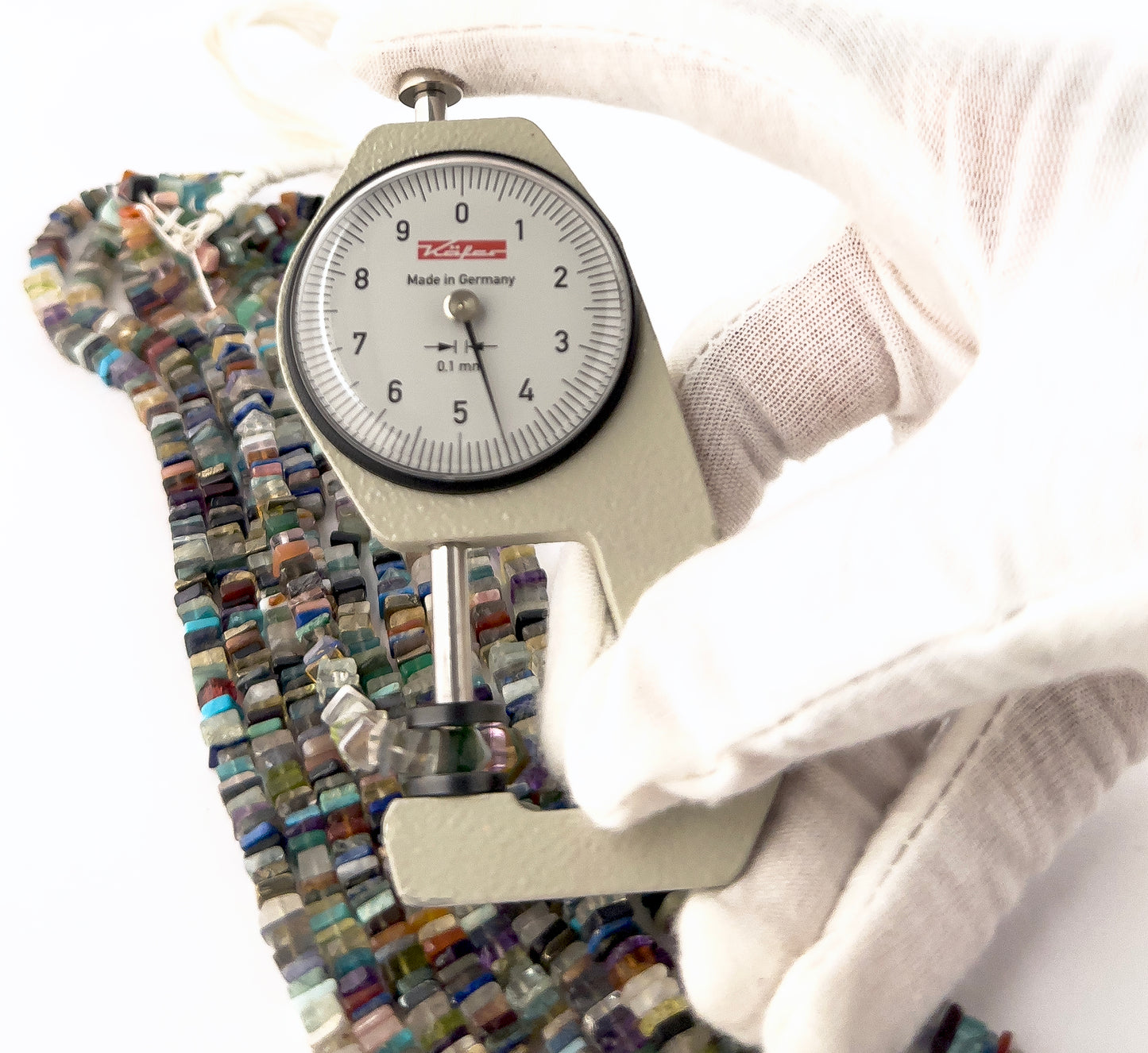 A dial gauge measures the Disco smooth heishi 4–4.5mm gemstone.