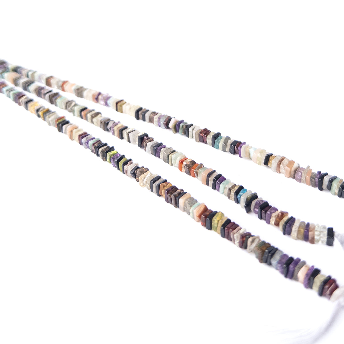 Close‑up of Disco Smooth Square Heishi beads revealing shine, shape and craftsmanship.
