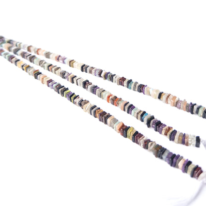 Close‑up of Disco Smooth Square Heishi beads revealing shine, shape and craftsmanship.