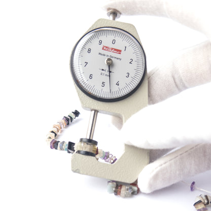 A dial gauge measures the Disco Smooth Square Heishi 4.7–5mm gemstone.  