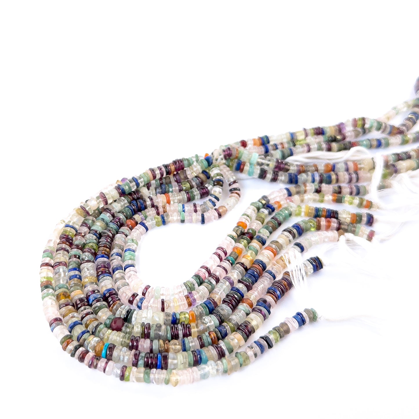 Disco smooth wheel heishi beads in mixed tones arranged on a strand for handmade jewellery components.