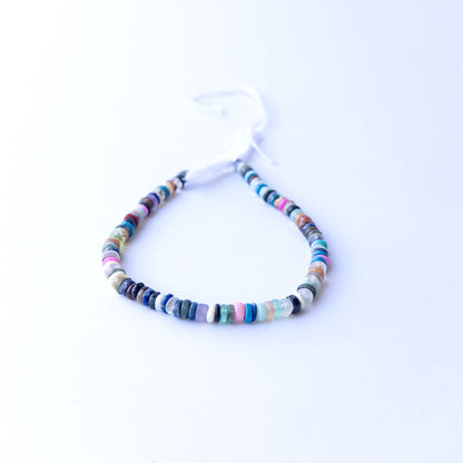 Strands of Disco smooth wheel heishi gemstone beads arranged neatly, showcasing their smooth finish and bright tones.