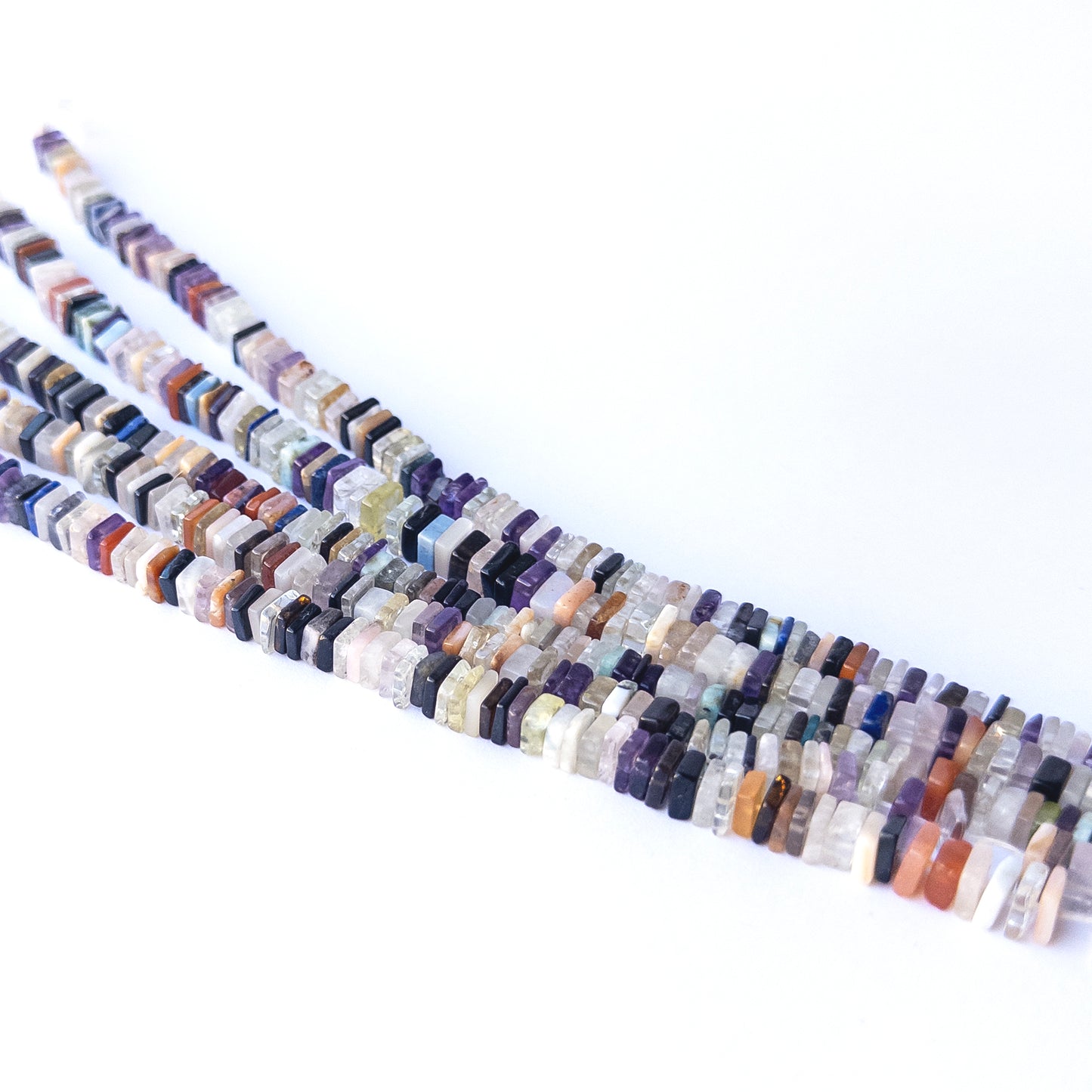 Mixed‑size Disco heishi beads arranged in strands, highlighting bold colours and high‑quality gemstone bead craftsmanship.