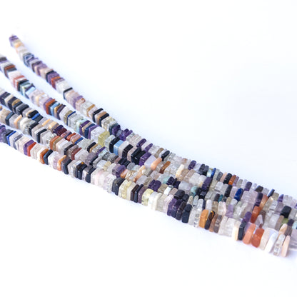 Mixed‑size Disco heishi beads arranged in strands, highlighting bold colours and high‑quality gemstone bead craftsmanship.
