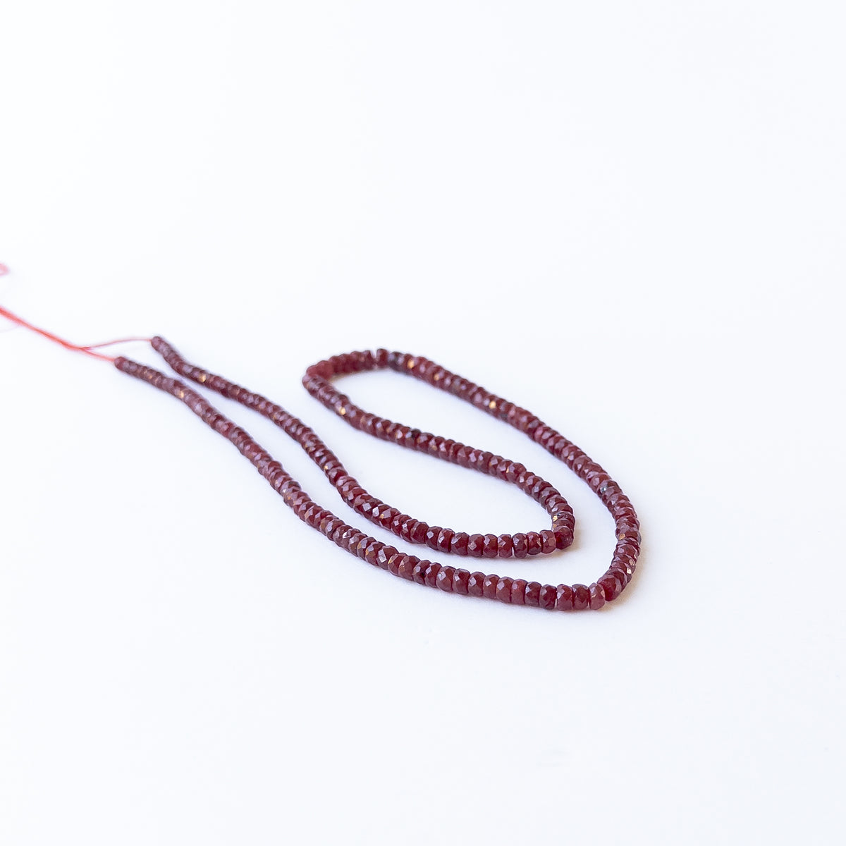 Authentic dyed Ruby gemstone beads displaying bright red colour and polished faceted shine.