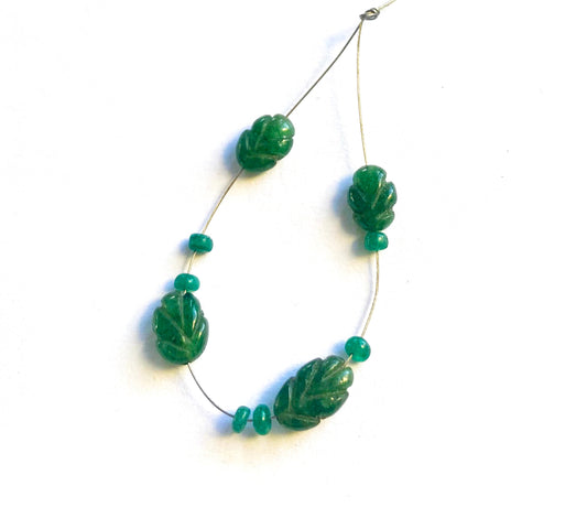 Emerald carved beads display deep green tones and elegant hand-cut details.