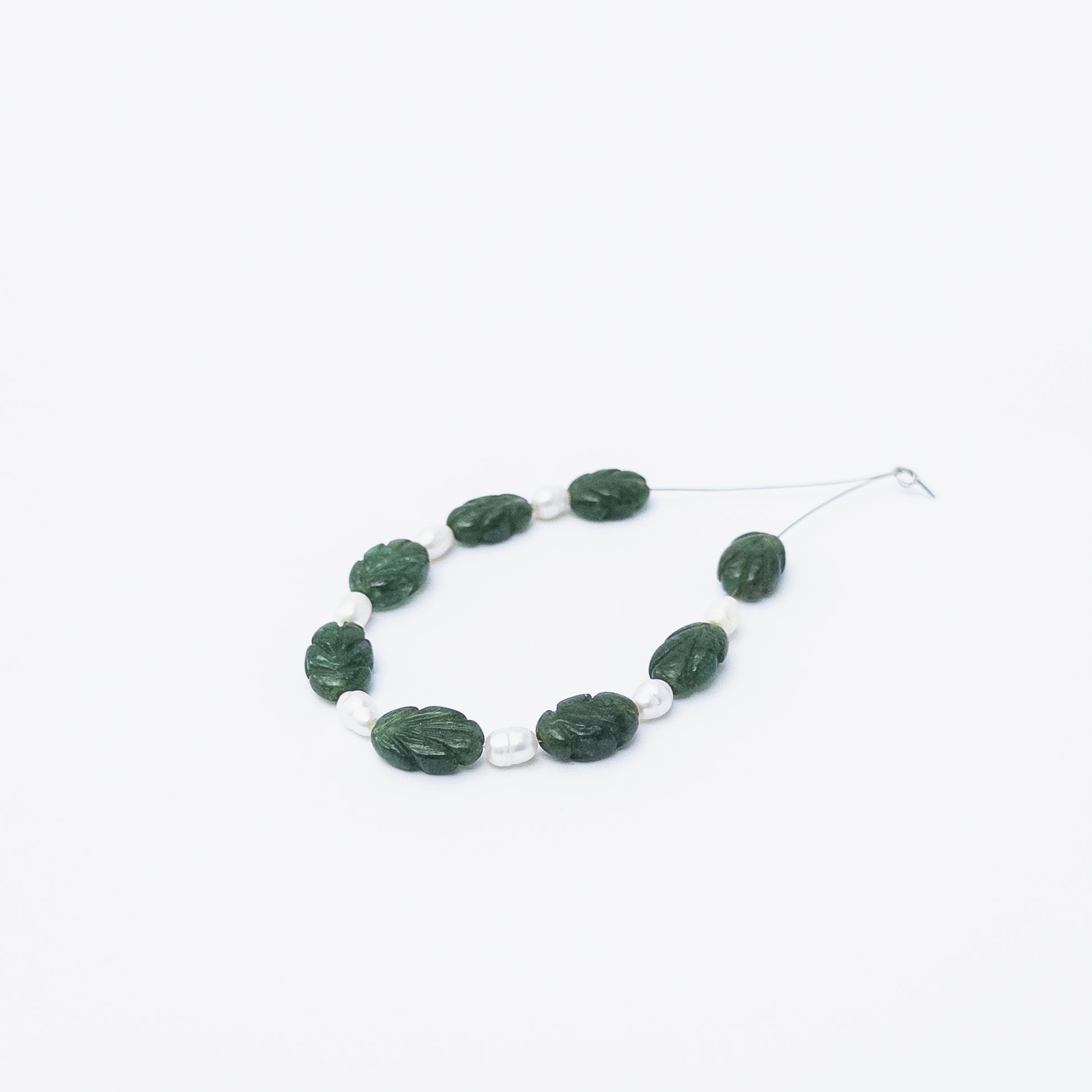 Authentic Emerald and Freshwater Pearl carved stone beads for DIY jewellery, displaying natural colour and fine detailing.