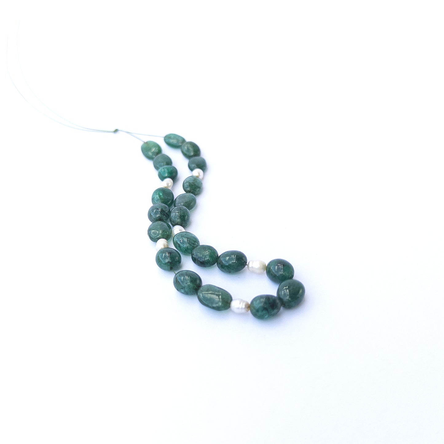 Authentic Emerald smooth oval beads paired with freshwater pearls highlighting elegant contrast and gemstone quality.