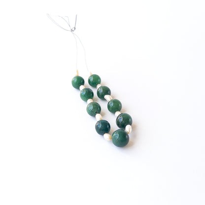 Authentic Emerald and Pearl gemstone beads displaying natural colour, clarity, and elegant round form for DIY jewellery makers.