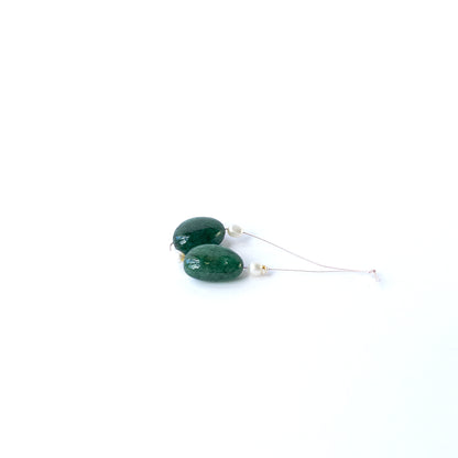 Emerald and freshwater pearl smooth tumble beads arranged together, showcasing natural colour contrast and handmade jewellery appeal.