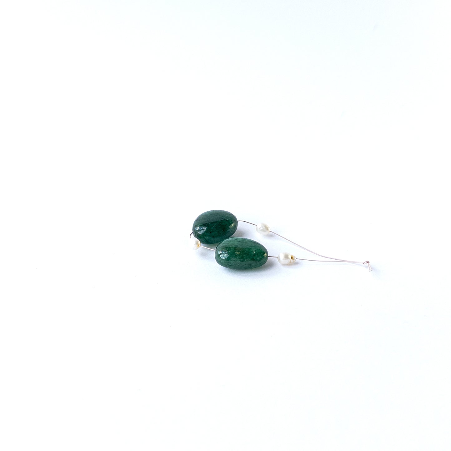 Authentic Emerald smooth tumble beads paired with freshwater pearls, highlighting natural texture and gemstone quality.