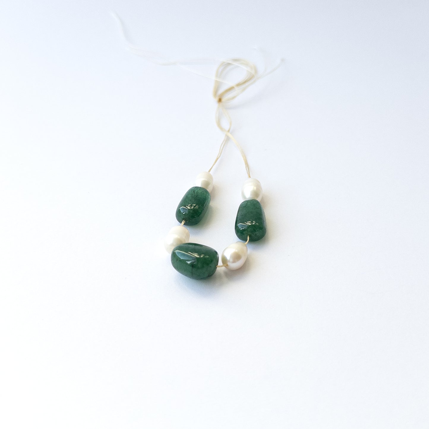 Authentic Emerald and freshwater pearl gemstone beads featuring polished smooth tumble cuts for DIY jewellery.