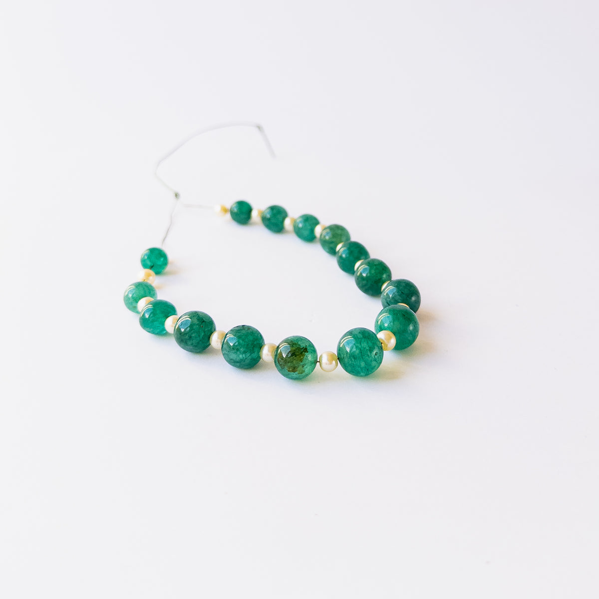 Authentic Emerald and Shell Pearl gemstone beads displaying polished finish and premium colour quality.