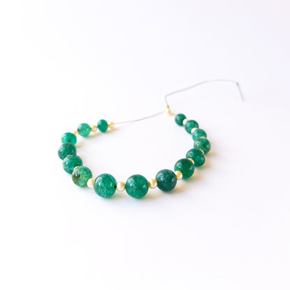 Emerald and Shell Pearl smooth round beads showing glossy shine and elegant green‑white contrast for handmade jewellery.