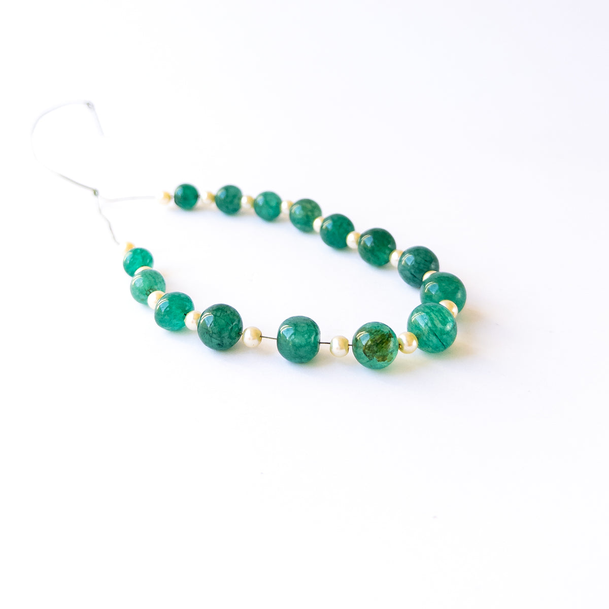 Smooth round Emerald and Shell Pearl beads in assorted 7.5–10.2mm sizes for artisan jewellery components.