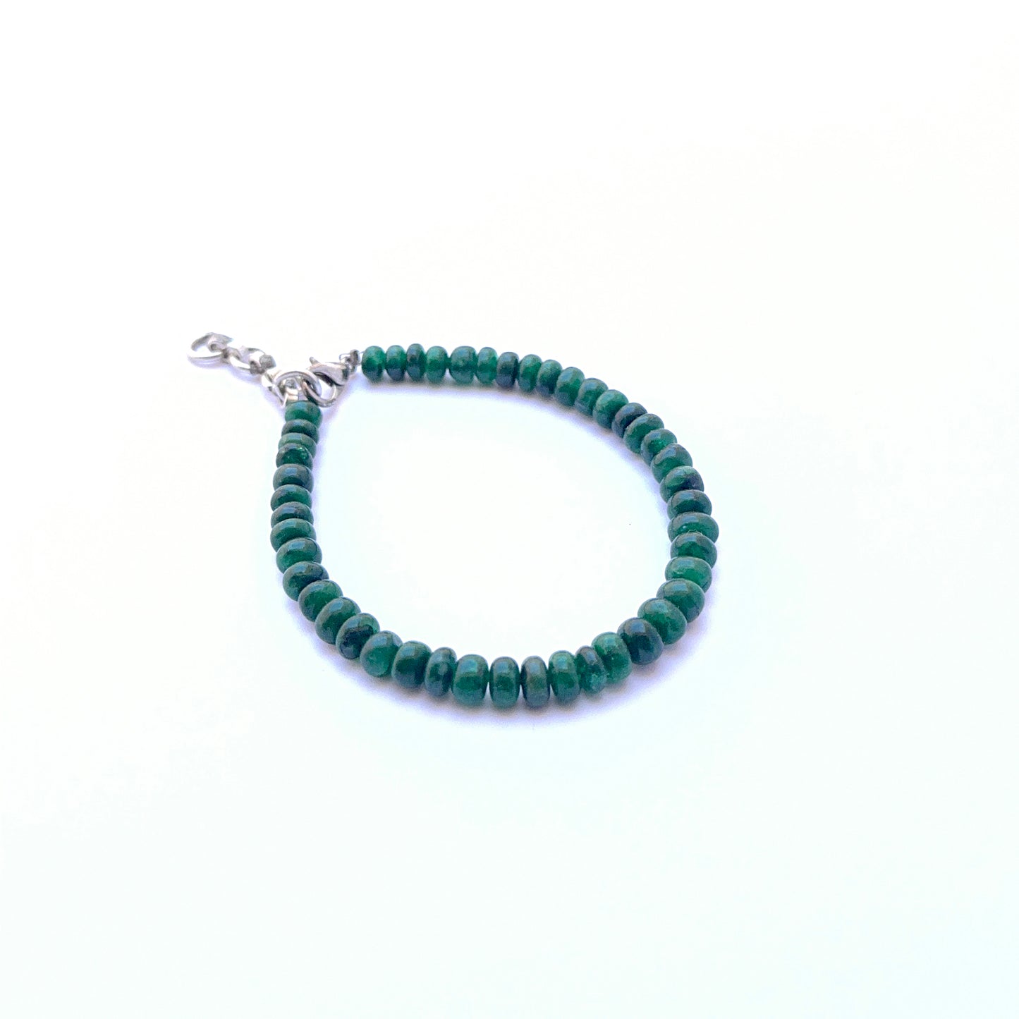 Emerald bracelet with rondelle beads showing shine and rich colour.