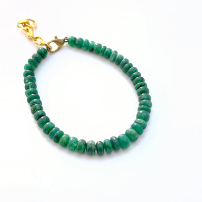 Emerald bracelet with smooth rondelle beads showing shine and colour.