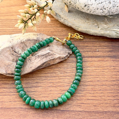 Emerald bracelet featuring smooth rondelle beads in rich green tones.