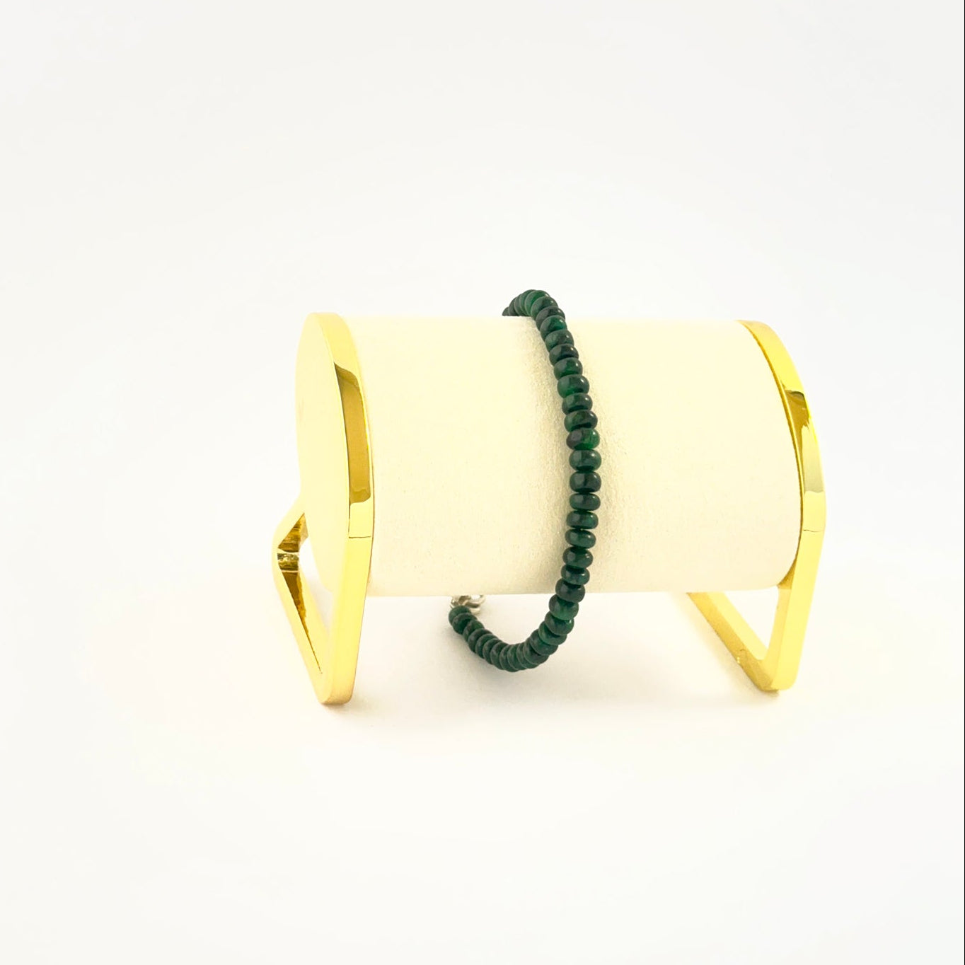 Smooth rondelle emerald bead bracelet crafted in a single adjustable strand.