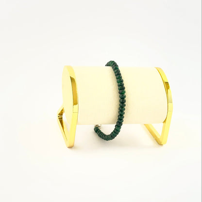 Smooth rondelle emerald bead bracelet crafted in a single adjustable strand.